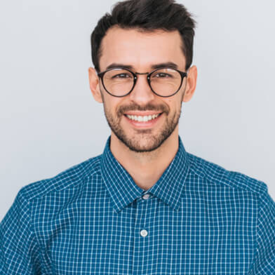 A man smiling after a successful emergency dental visit.