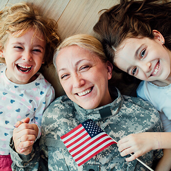 Servicewoman mom with her two happy daughters