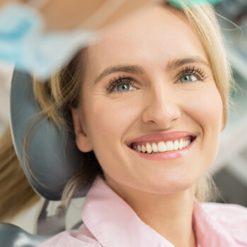 smiling woman talking with her dentist