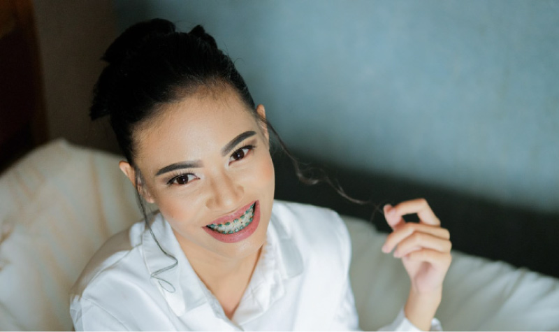 girl with braces twirling her dark hair