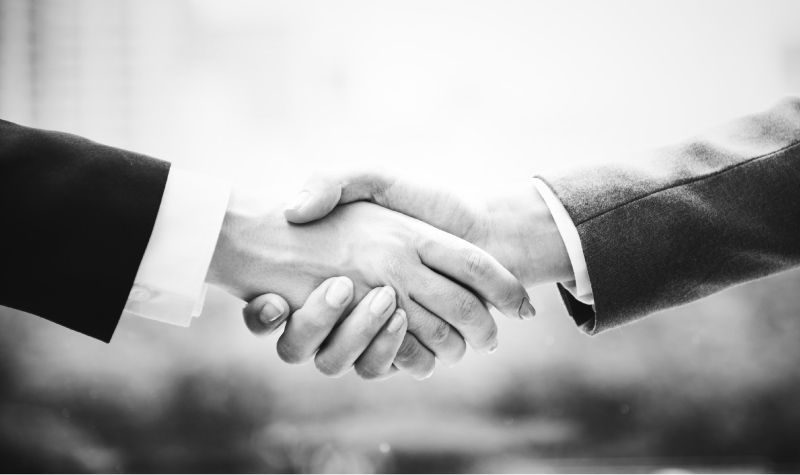 shaking hands showing trust in one dental practice